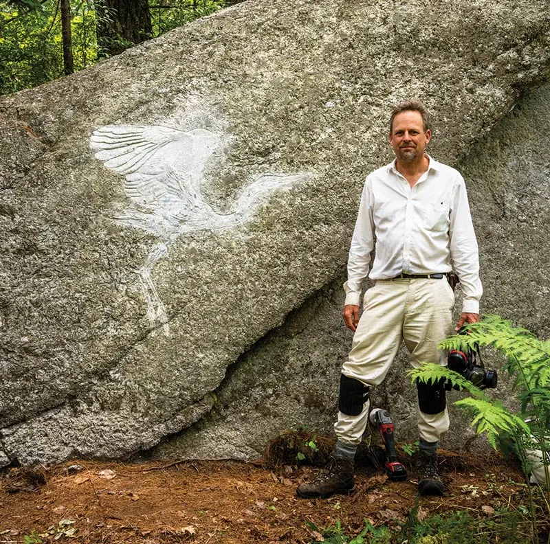 Kevin Sudeith and one of his stone carvings