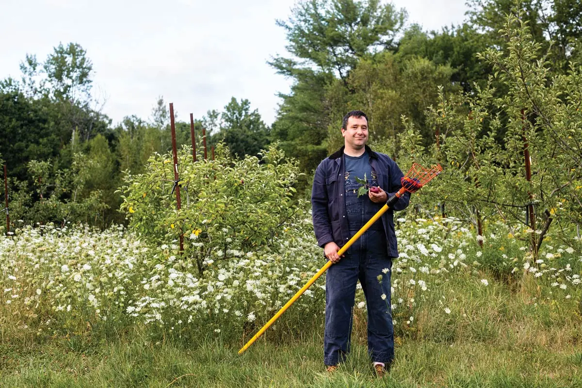 Sean Turley holding apple picker tool