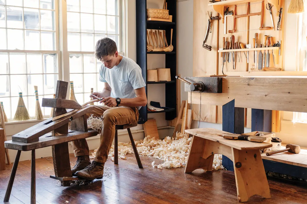Broom making is a surprisingly physical art, says Eric McIntyre, owner of Village Handcraft. His workshop participants need some dexterity (not just for the cleanup).