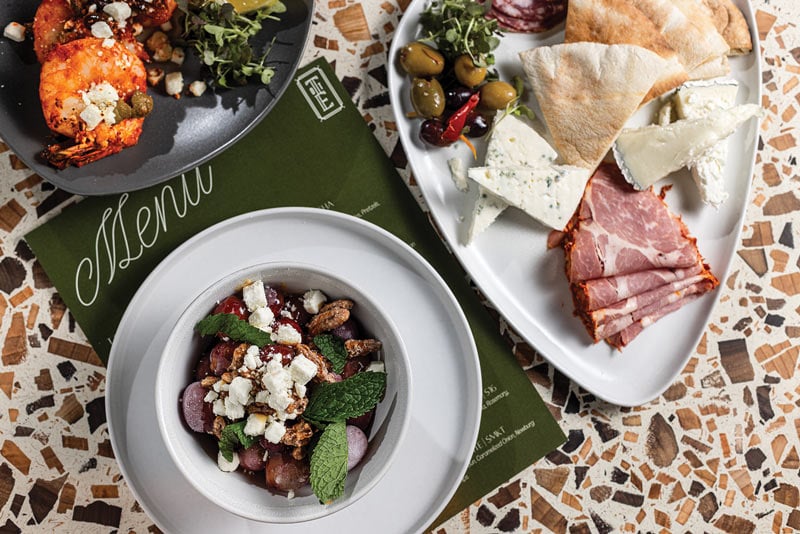 Some of the food at Top of the East: harissa-roasted shrimp, a charcuterie board, and frozen grapes with feta, candied pecans, and mint.