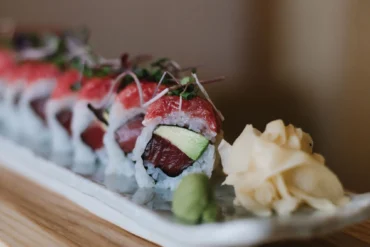 Miyake’s Super Toro Roll filled with tuna and avocado and topped with diced toro, scallions, and microgreens.