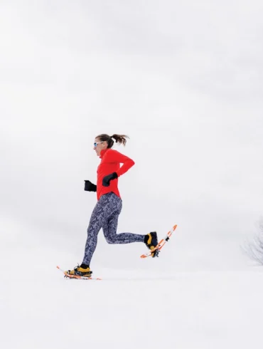 Woman running on snowshoes