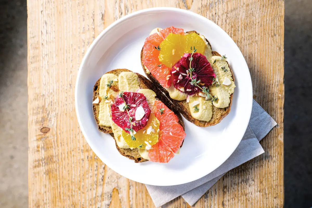 a Citrus Got Real, with orange, blood orange, and grapefruit, cashew “ricotta,” and sliced almonds from Toast