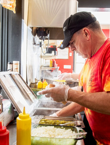 Jimmy Simones working the line at Simones' Hot Dog Stand in Lewiston, Maine