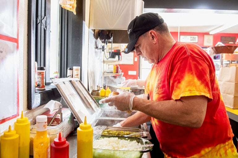 Jimmy Simones working the line at Simones' Hot Dog Stand in Lewiston, Maine