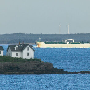 Rockport’s Indian Island Light in the foreground with a oil/chemical tanker ship and wind mills in the background