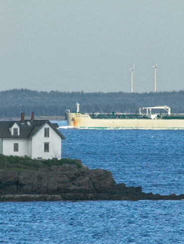 Rockport’s Indian Island Light in the foreground with a oil/chemical tanker ship and wind mills in the background