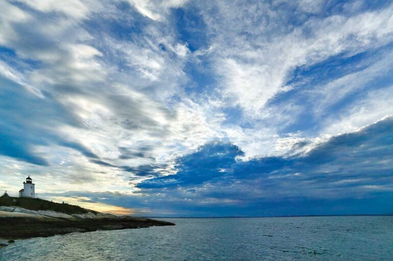an approaching storm encroaches the Deer Island Thorofare Light, on Mark Island, off Stonington.