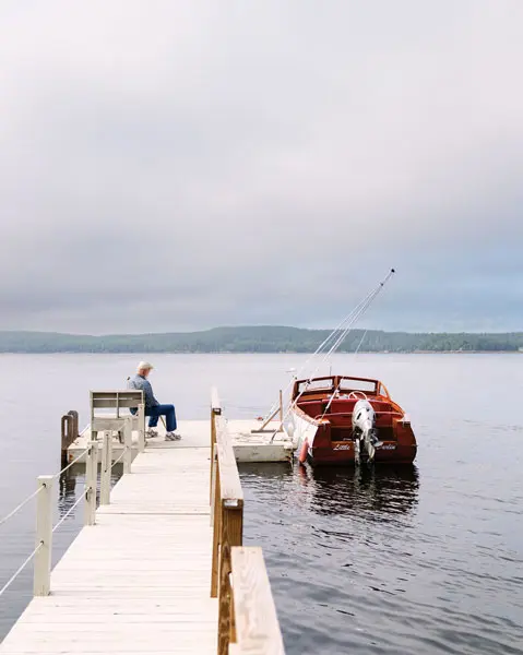 Philosopher Daniel Dennett sitting on a dock