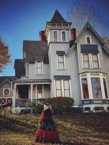 Tizz Crowley in her “Civil War widow” dress outside Auburn’s William A. Robinson owned and decorated by Migdalia Mass