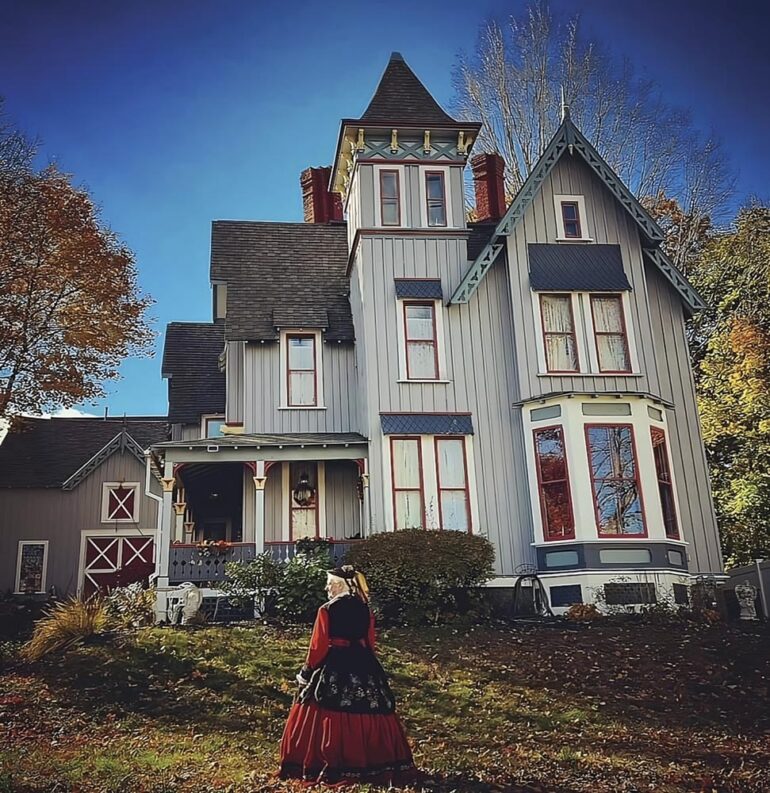 Tizz Crowley in her “Civil War widow” dress outside Auburn’s William A. Robinson owned and decorated by Migdalia Mass
