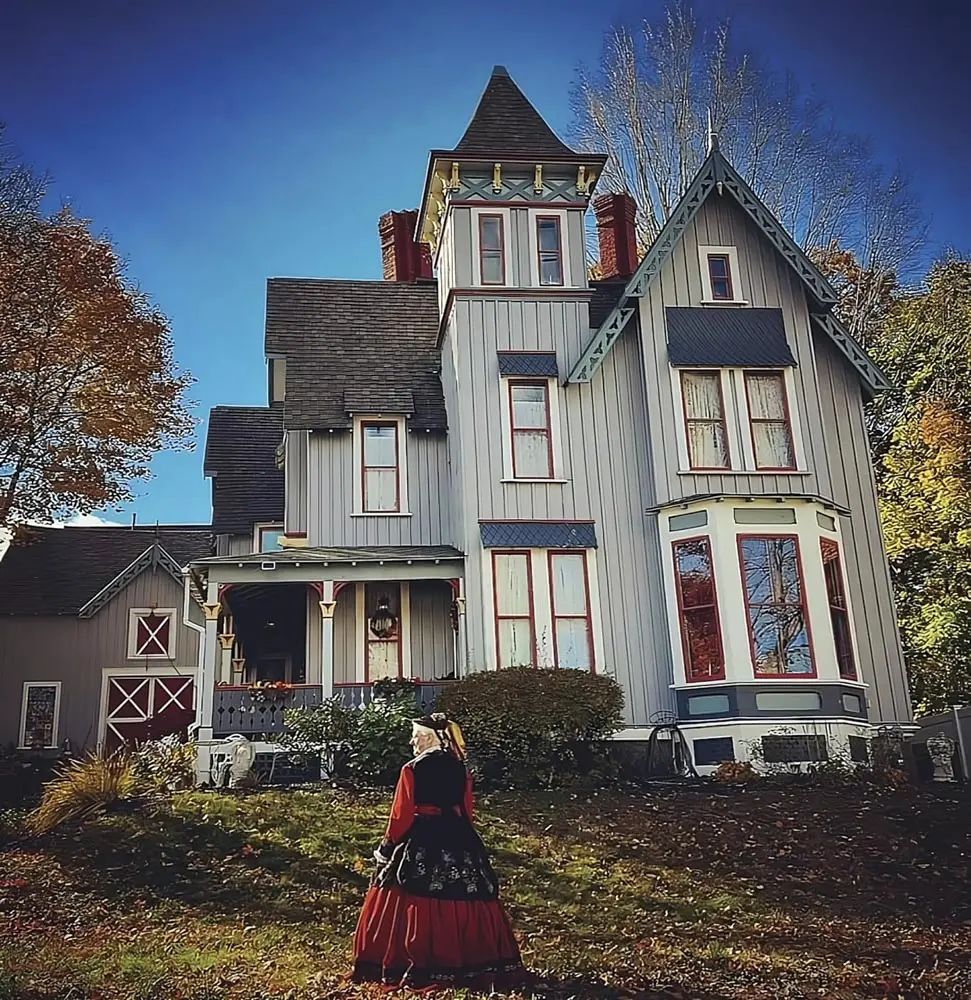 Tizz Crowley in her “Civil War widow” dress outside Auburn’s William A. Robinson owned and decorated by Migdalia Mass