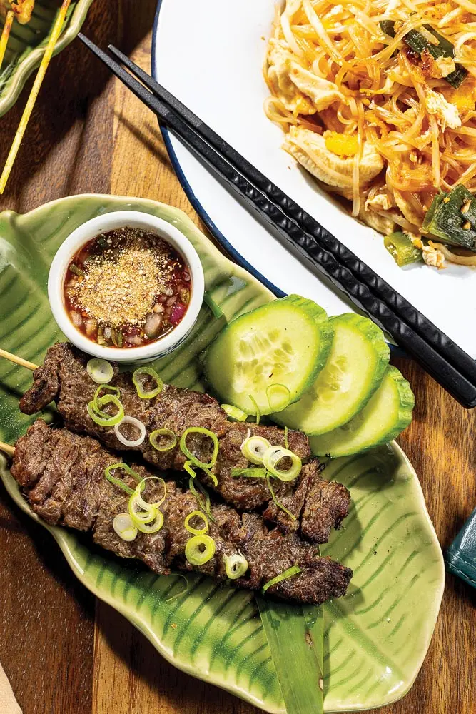Pad thai laced with sweetened tamarind juice and lemongrass beef skewers served with spicy-tart Jaew sauce