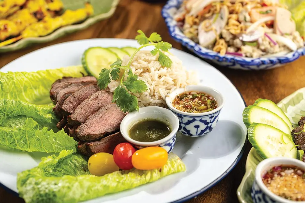 The Crying Tiger, with grilled sirloin, garlic rice, and chili-garlic-lime and Jaew sauces.