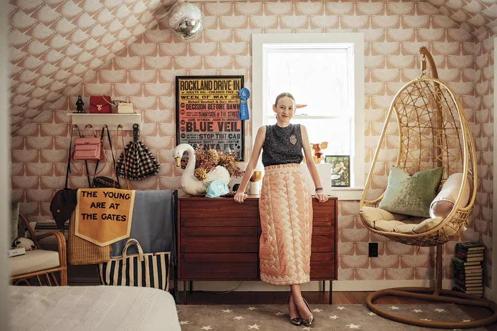 Riley's room contains peel-and-stick stylized-bird wallpaper, a wool rug strewn with stars, and a walnut dresser all from West Elm Kids
