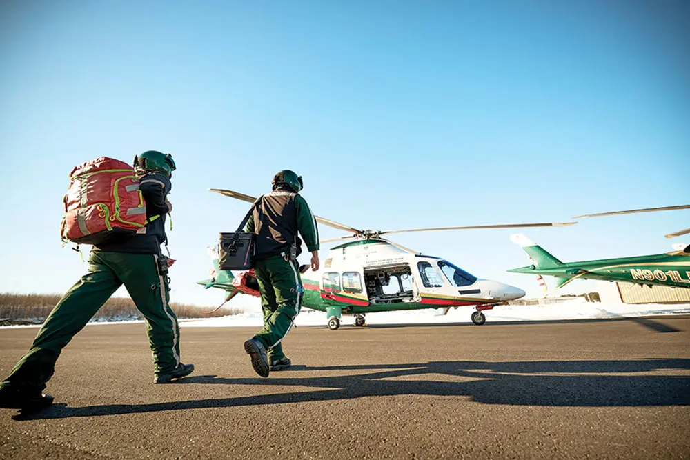 LifeFlight of Maine pilots geared up and walking towards their helicopters