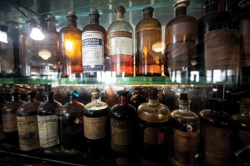 bottles of elixirs, oils, syrups, and tonics