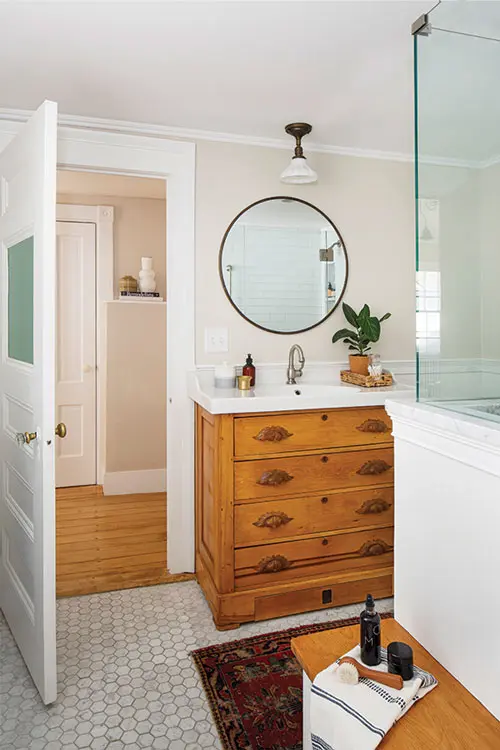 Yarmouth’s Pearce Builders to update the boys’ bath, walling over a door and turning a vintage pine chest, unearthed at a Biddeford barn sale, into a vanity with a porcelain IKEA countertop
