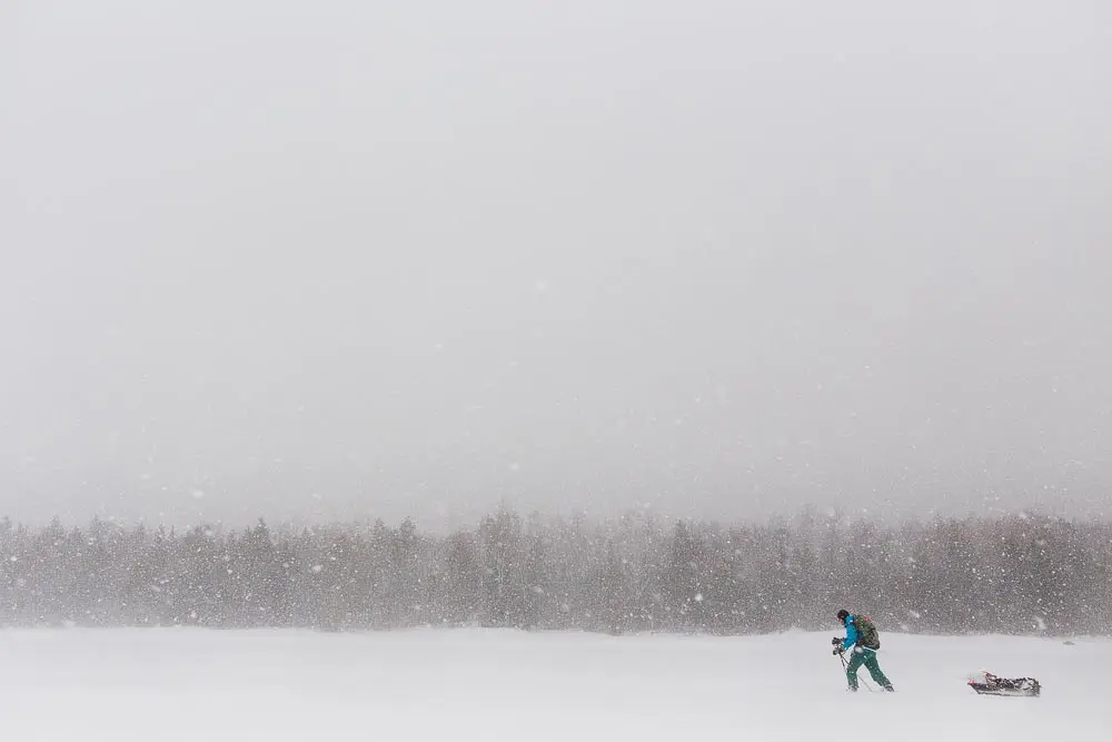Wendy Weiger and her sled snowshoeing to her winterized cabin on First Roach Pond