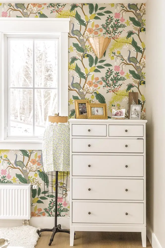 flower-like Anthropologie sconce emerges from the vines in Rifle Paper Co. wallpaper