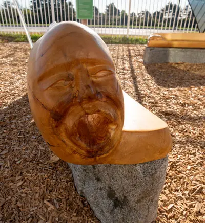 Tim Shay designed the play environment to include cedar benches into which he carved Wabanaki archetypes — the eagle, the turtle, and the “singing grandmother.”