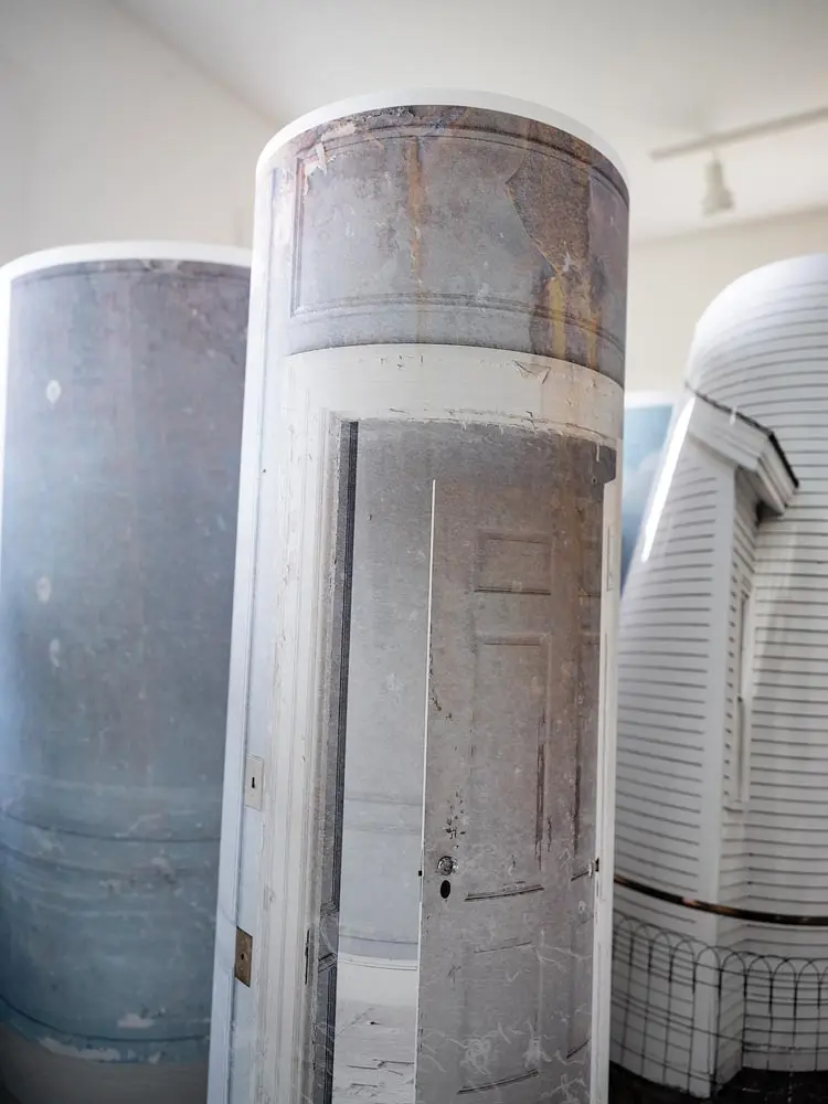 Jeffery Becton's photomontage prints rolled up into cylinders