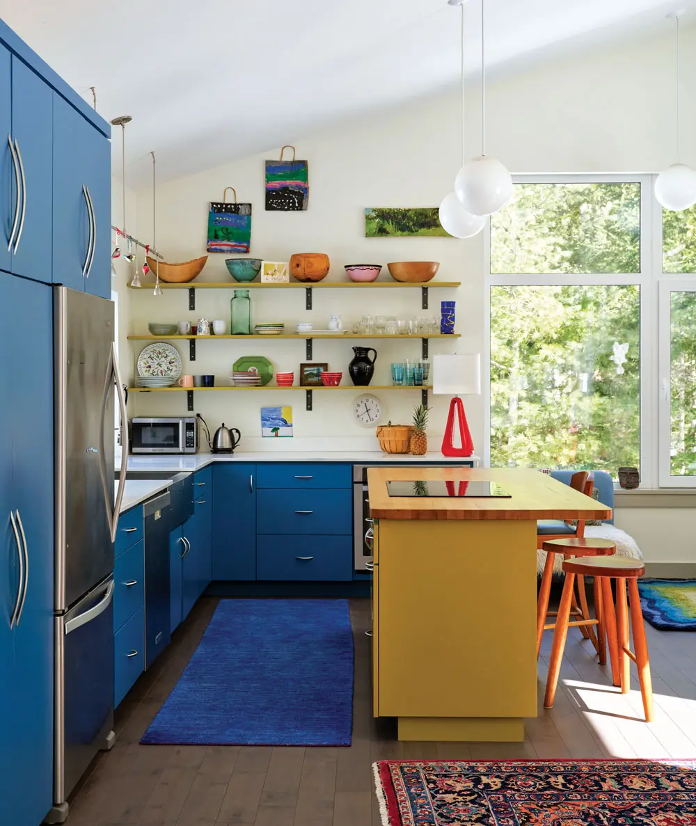 a Mondrian-esque palette in the kitchen, which features cabinetry from New Brunswick’s Classic Woodworking and a maple butcher-block island and cherry stools by Cutler’s Scott Carpenter