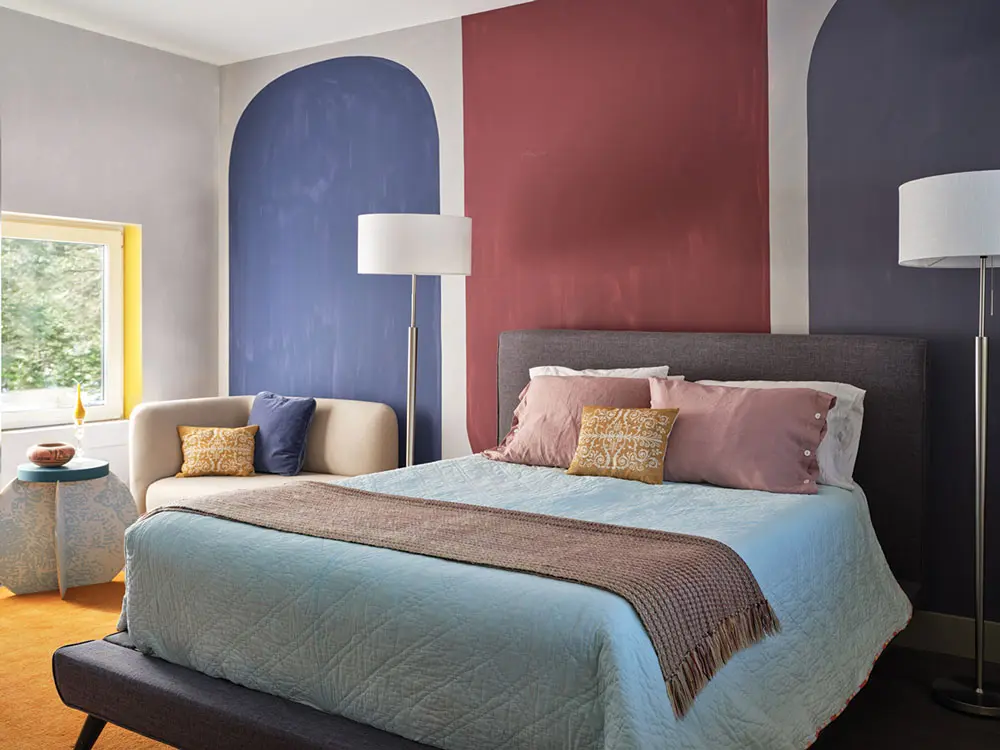 In the bedroom Colin Sullivan-Stevens painted the abstract mural and applied a whitewash that resembles old plaster to the surrounding walls