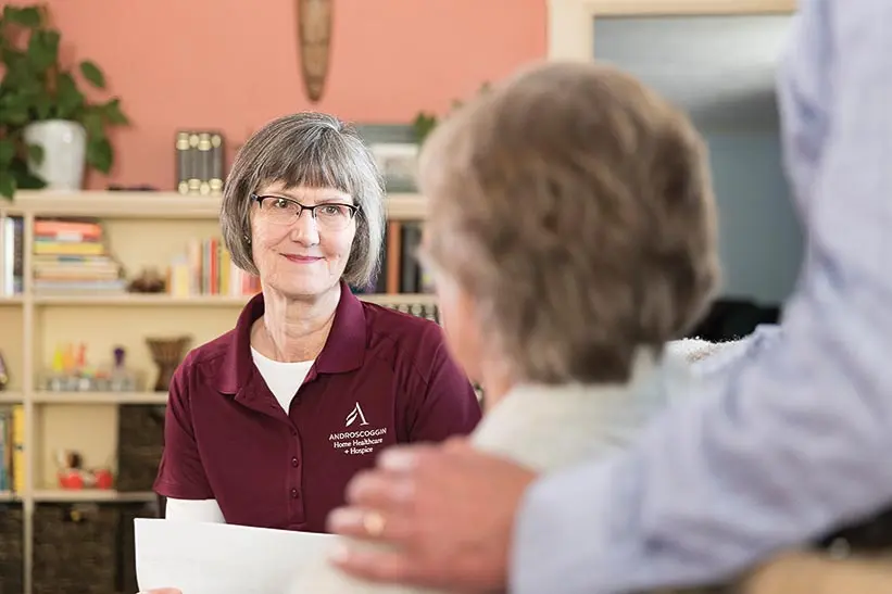 Androscoggin Home Healthcare and Hospice employee talking with patient and family