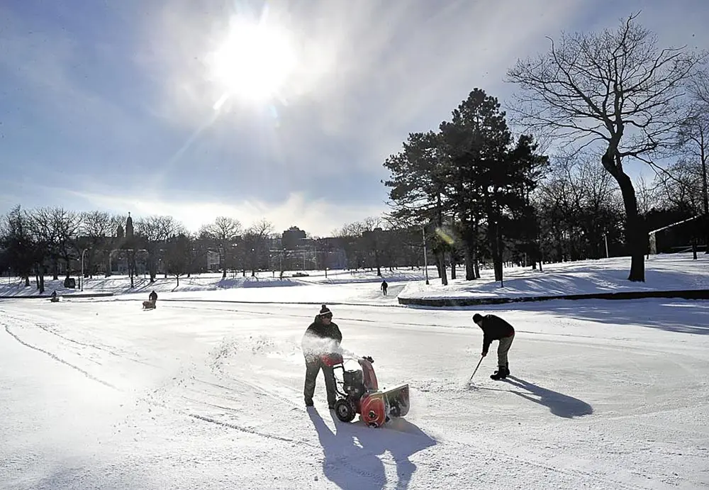 A crew from Portland's Athletic Facilities Dept. clear snow from the ice at Deering Oaks pond that will be ready for skaters,Thursday, January 3,2013. (Photo by John Patriquin/Portland Press Herald via Getty Images)