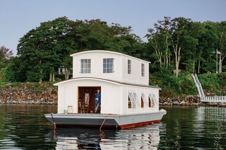 Rockport boatbuilder Timo Foster spent five years restoring this 1929 floating home, pictured in Camden Harbor; the owner is currently looking for a more out-of-the-way spot to anchor.