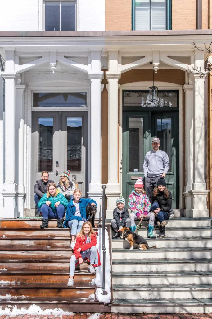 Todd and Catherine Alexander, with kids Sally, Grace, and Paige, and pup Hobie, and Ian and Kate Malin, with kids Josie and James, and pooch Dixie, pose in their favorite hangout spot.