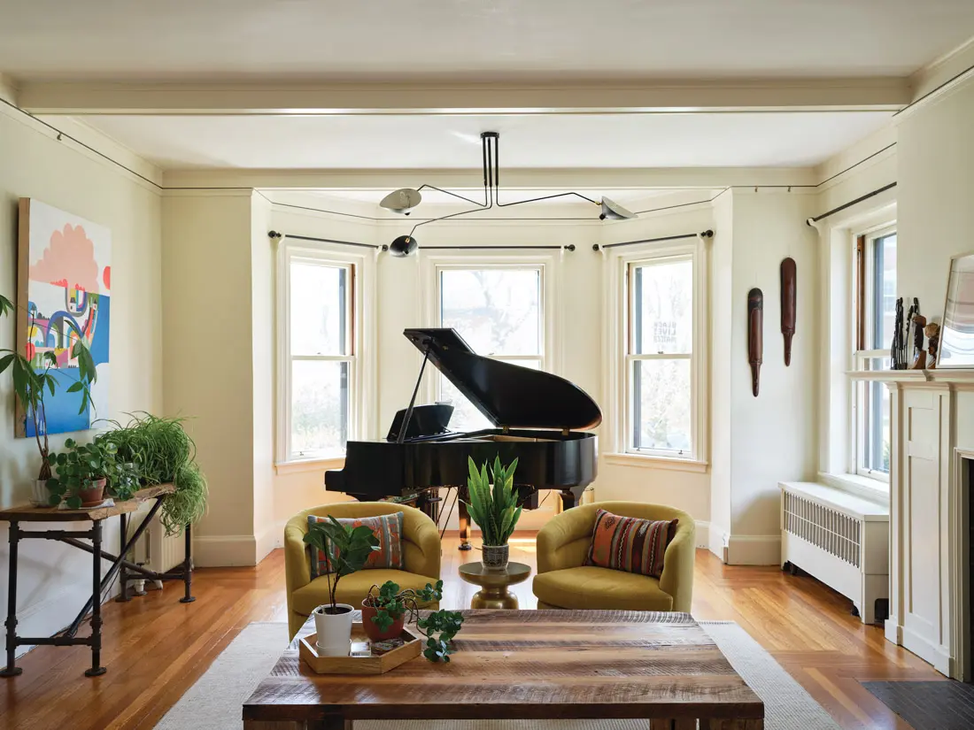 in the living room, West Elm swivel chairs that can face the baby grand or a puzzle on the reclaimed-wood coffee table