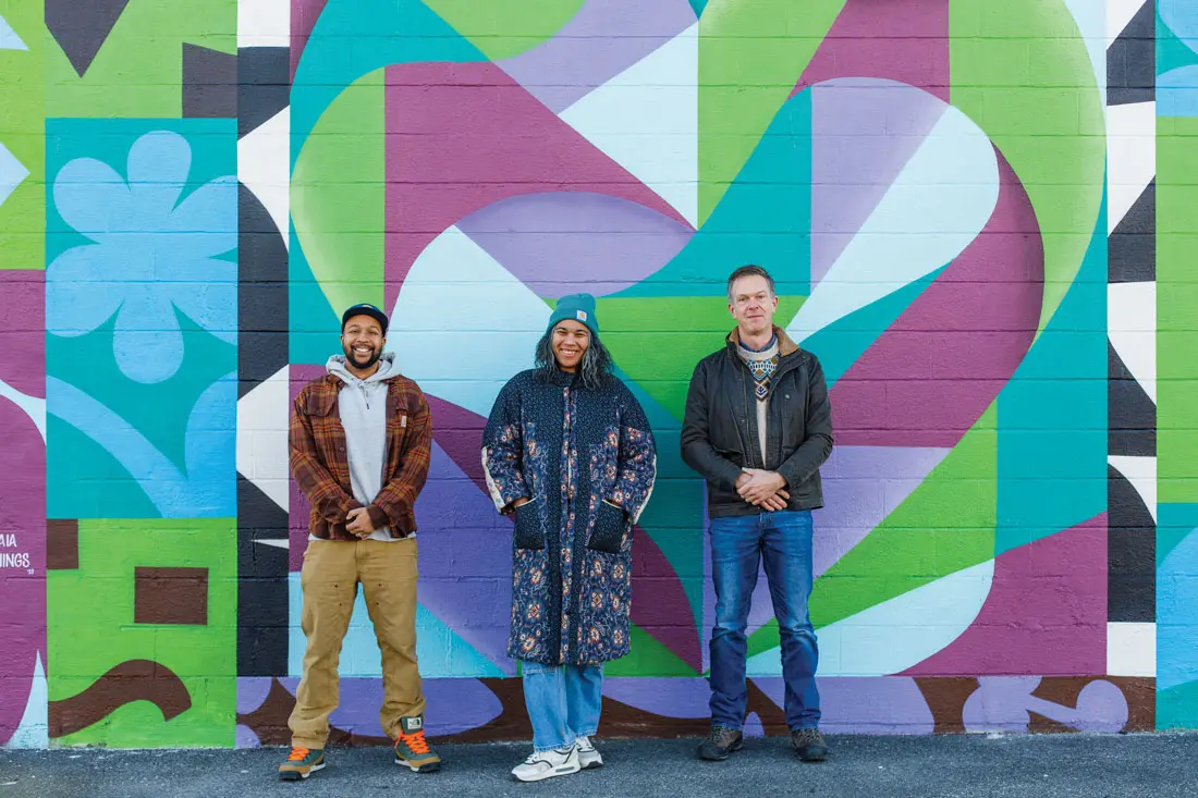 The mural It’s a Beautiful Day, Whenever We’re Together, by Ryan Adams and Rachel Gloria Adams (pictured with developer Chris Thompson), welcomes visitors to Thompson’s Point.