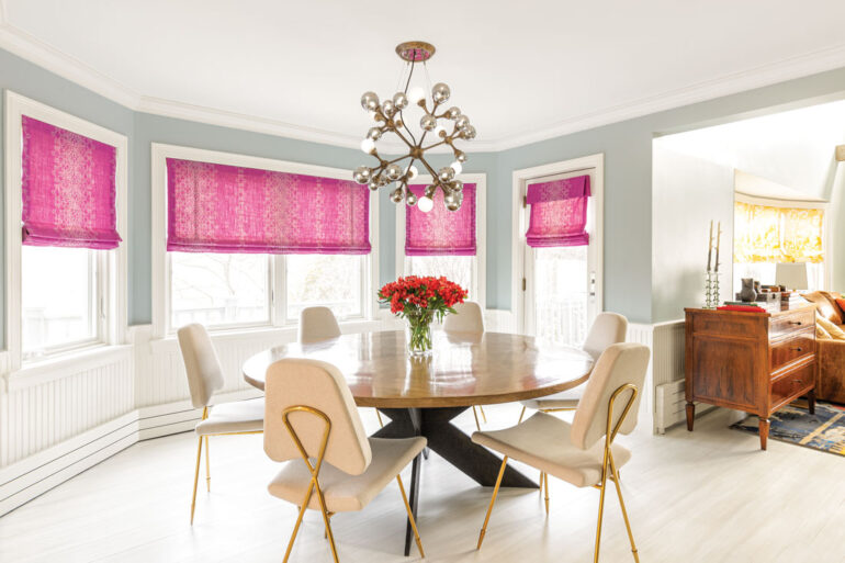 Lisa Fine Textiles Roman shades, a Sputnik-style chandelier, and a Jonathan Adler table and chairs give the dining area a boho-glam vibe.