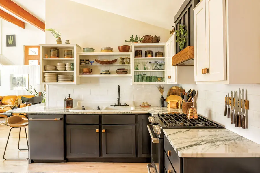 he kitchen received a facelift courtesy of fresh paint on the existing cabinets, a custom range hood by local carpenter Joe Maclean, and new appliances and Danby marble countertops.