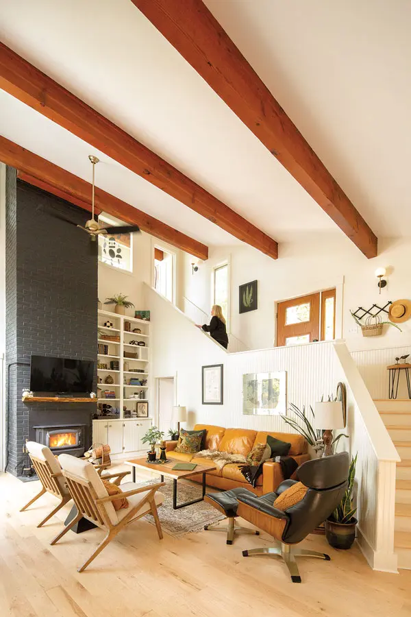 Grandkids visit a lot, so she decided not to put the “real stuff” in the living room, furnishing instead with sturdy mid-century reproductions.