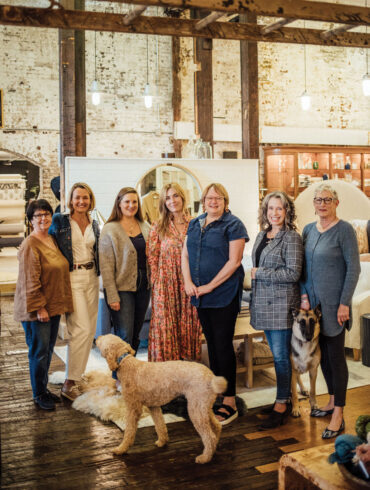 Rachel Ambrose (fifth from left) and her Home Remedies team pictured with shop dogs Prince Harry and Sage