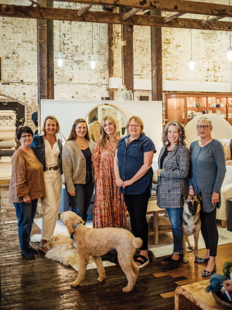 Rachel Ambrose (fifth from left) and her Home Remedies team pictured with shop dogs Prince Harry and Sage