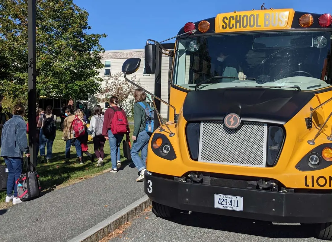Mount Desert Island High School student boarding the first electric school bus in Maine