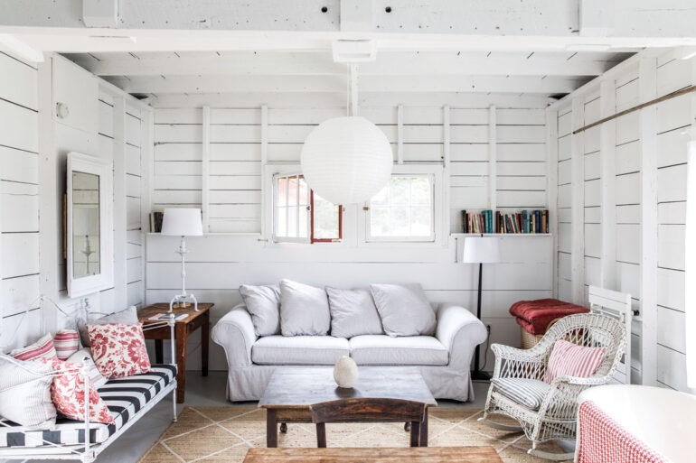 A sofa from a Massachusetts Crate & Barrel’s “scratch and dent” section and a jute rug anchor Lynn Krauss and Stephen Blatt’s Vinalhaven guesthouse, which also sports a tiny kitchen and a claw-foot tub.