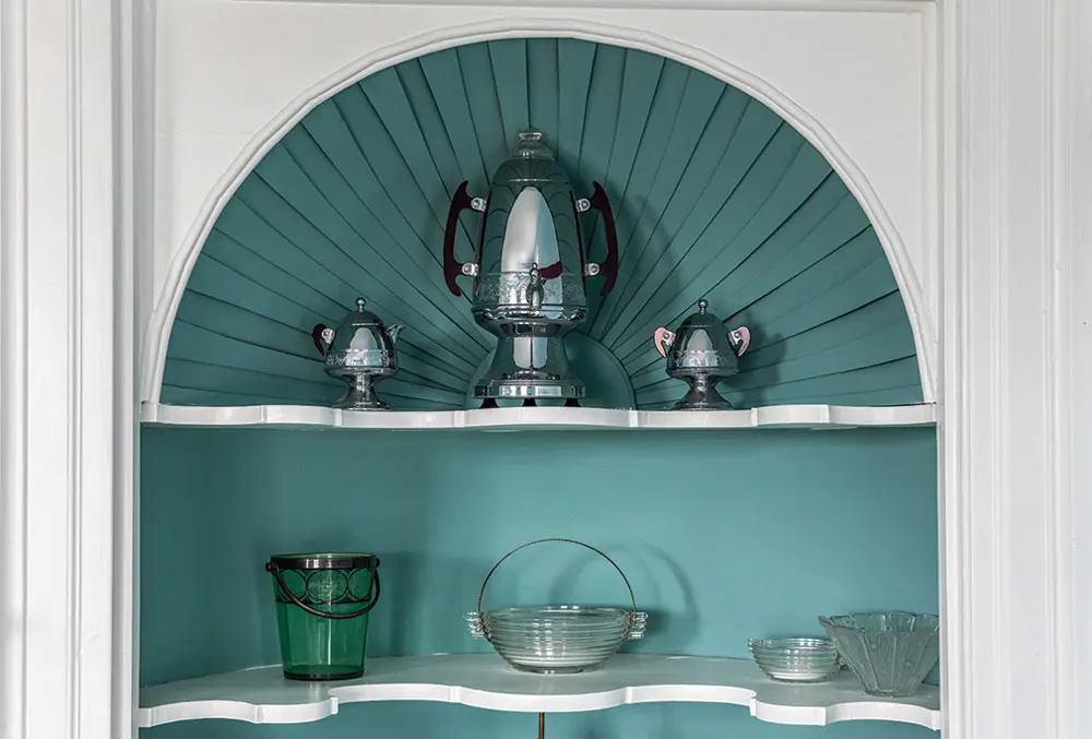 Built into a parlor closet in the early 20th century, this shell-shaped cupboard displays a 1930s chrome United “rocket” coffee service with Bakelite handles.