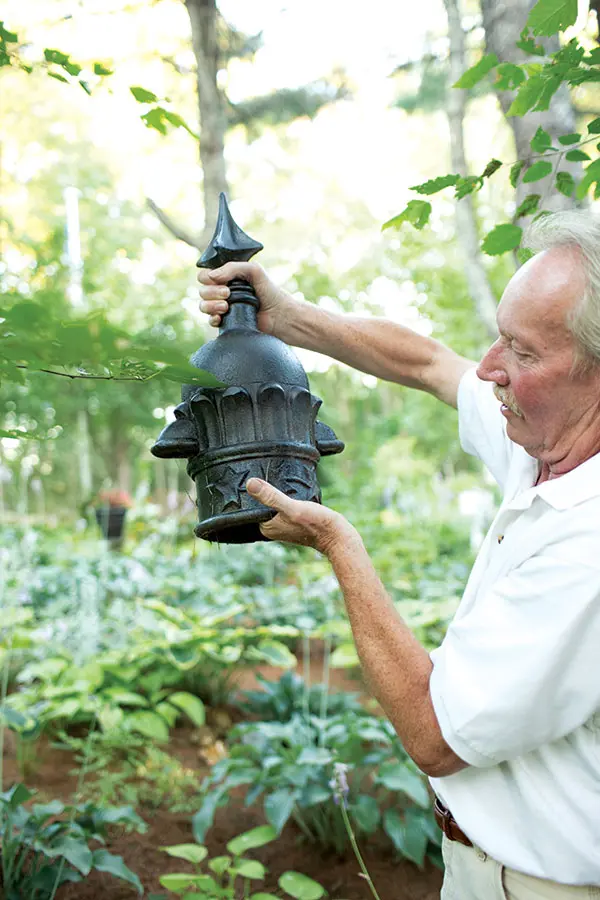 Eric Allen holding architectural salvage turned garden ornament