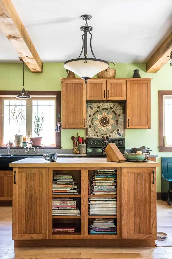 Decorative versions of the rustic exposed beams that support Spanish Revival homes and a mandala mosaic backsplash by Sarah Sorenson.