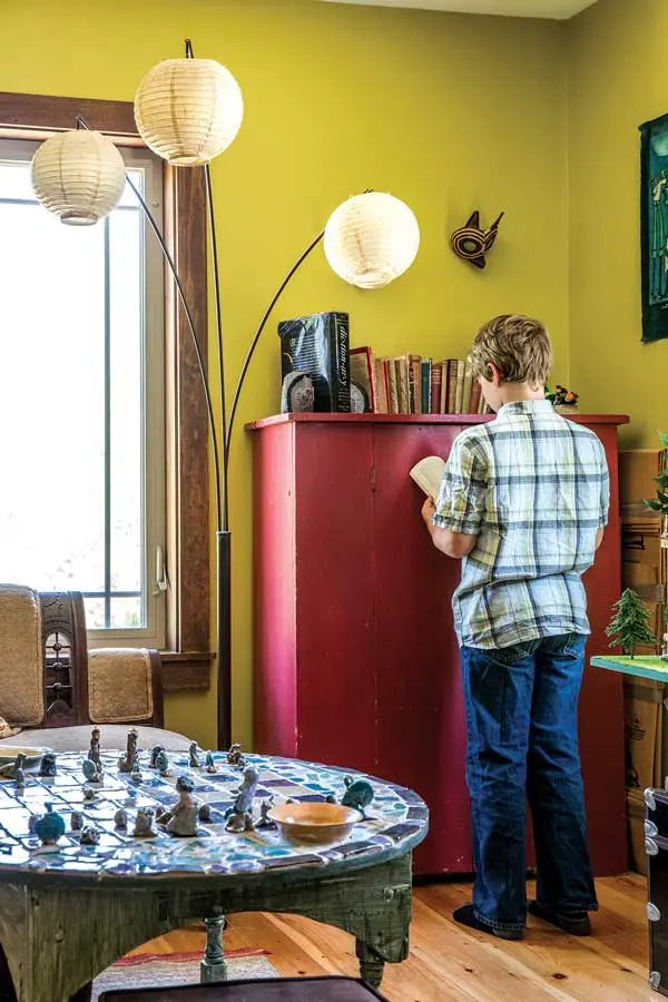 In the second-floor library, a card table rescued from the side of the road showcases a clay chess set