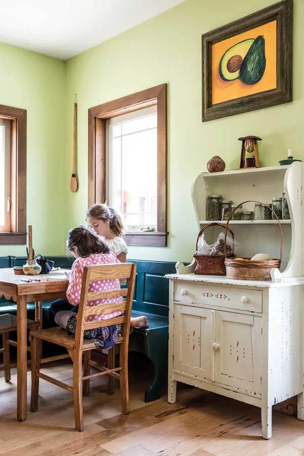 A spectrum of greens enlivens a kitchen corner with a hand-me-down table and chairs