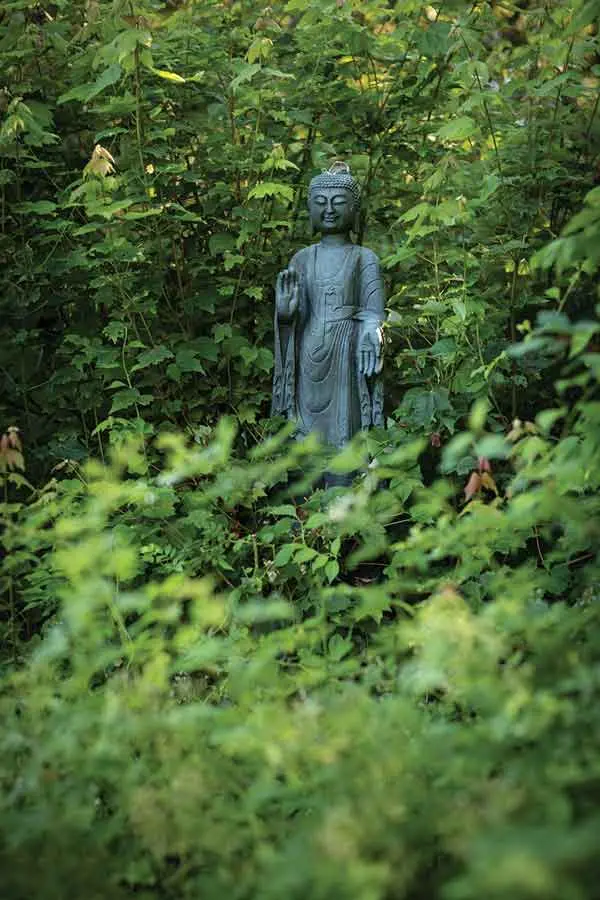 A Buddha statue gazes benevolently over the garden’s western entrance