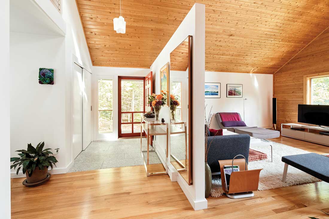 For an MDI Couple, One Renovation Led to Another the team installed new granite entry tile from Orland’s Freshwater Stone, removed dark wood trim on the windows and partial walls, and refinished the maple flooring in the living room