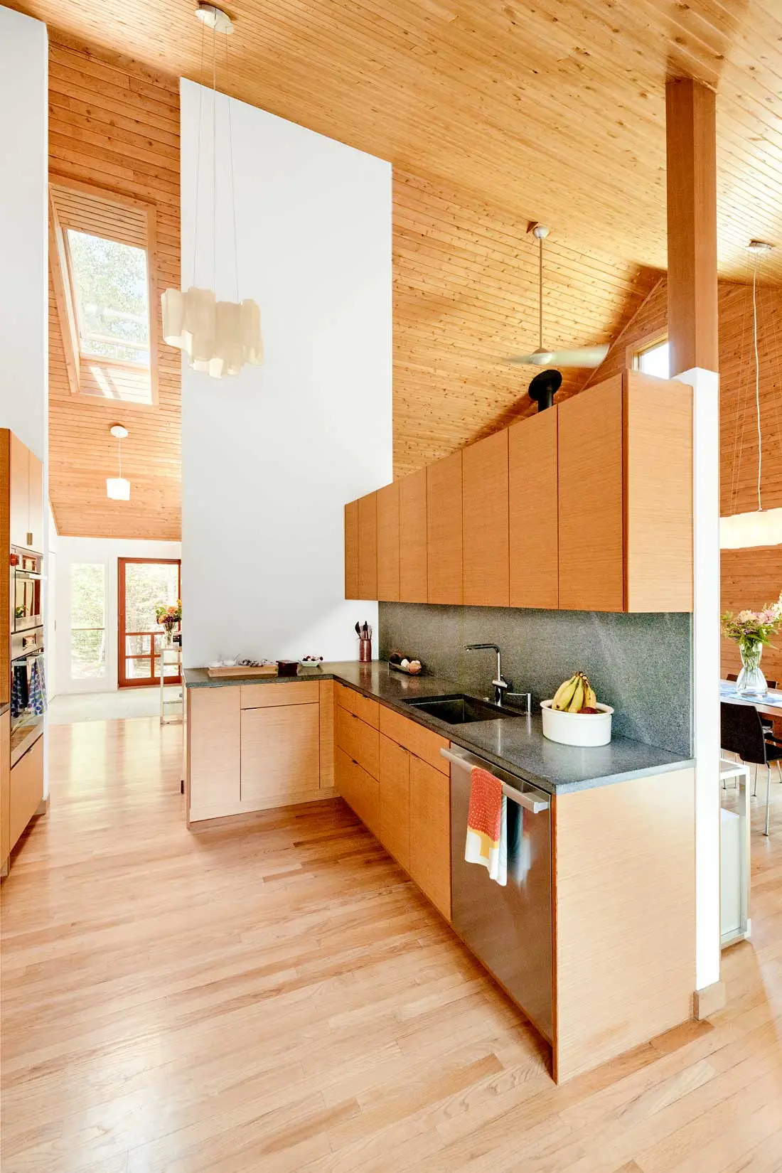 For an MDI Couple, One Renovation Led to Another vertical-grain fir contrasts with a Morning Mist granite countertop and backsplash from Freshwater Stone and the home’s knotty-cedar paneling