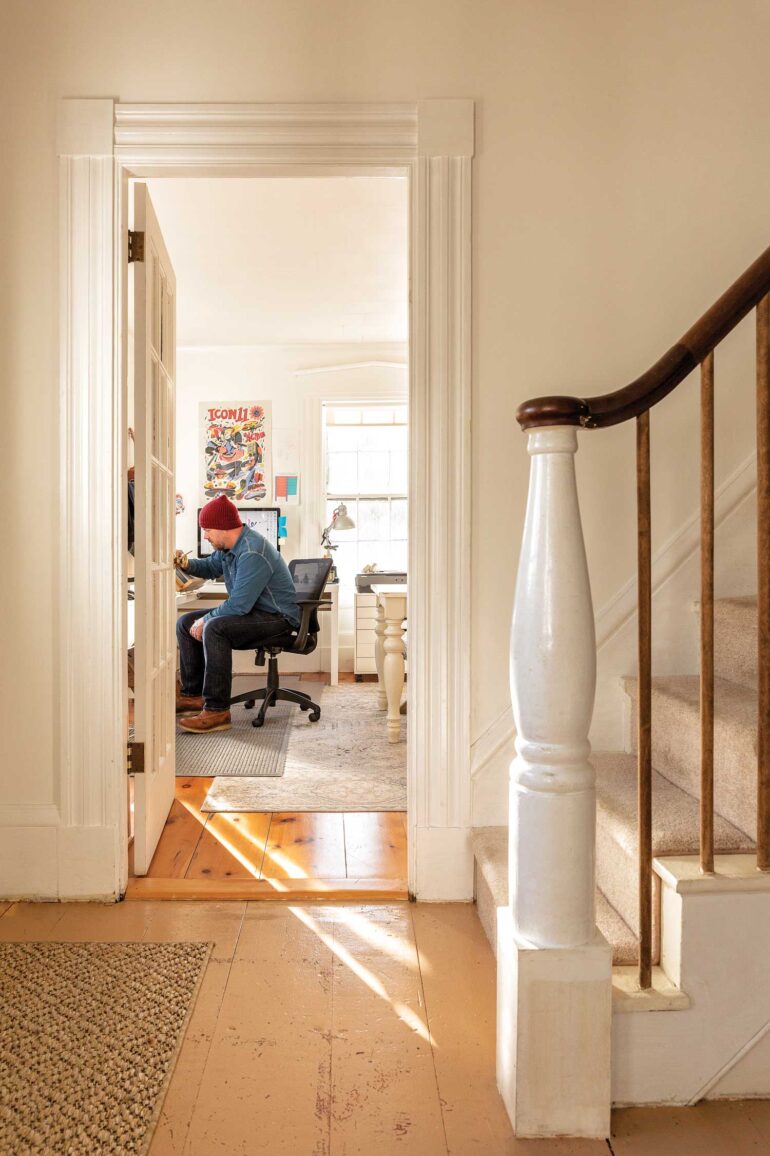 Andrew DeGraff works at a mid-century drawing table in the Waldoboro home he shares with Michelle Provencal